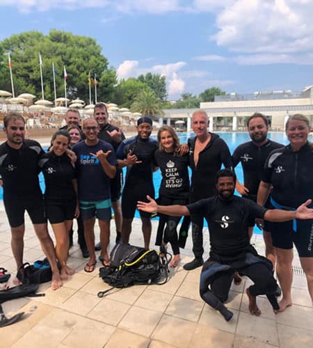Gruppo di subacquei pronti per immersione in piscina.